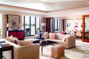 a living room with couches and a dining room at Ritz Carlton DIFC Downtown Dubai in Dubai