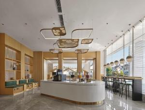 a lobby of a store with a counter and chairs at Hilton Garden Inn Kunming Dianchi in Kunming