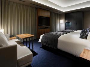a hotel room with a bed and a couch at Mitsui Garden Hotel Gotanda - Tokyo in Tokyo