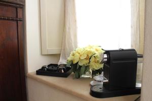 a vase of flowers on a counter next to a window at Terre Di Vendicari in Noto