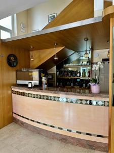 a bar in a restaurant with a counter at Hotel Enna Rimini in Rimini