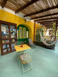 a patio with a yellow table and chairs in a building at Casa Gialla B&B in Lipari