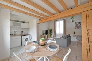 a kitchen and living room with a table and chairs at La TOUR DES TEINTURIERS - AC CLIM - WiFi - BALCON in Avignon