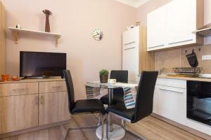 a kitchen with a table and chairs in a kitchen at Apartment Fiume in Rijeka