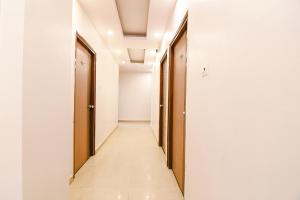 a corridor of corridors in an office building with doors at FabHotel SS Residency in kolkata