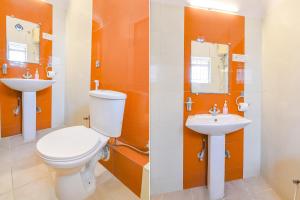 a bathroom with a toilet and a sink at FabHotel SS Residency in kolkata