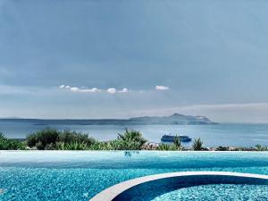 a swimming pool with a view of the ocean at Villa Icare in Kókkinon Khoríon