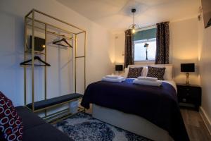 a bedroom with a bed with a mirror and a window at Moray Court Chester City Centre Studio Apartment by Rework Accommodation in Chester