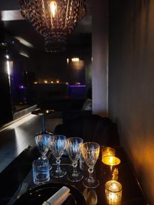 a table with wine glasses on it in a restaurant at Le Clos des Thermes Suites de Luxe avec wellness privatif in Chaudfontaine