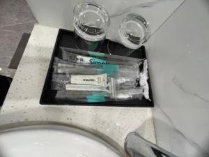 a tray on a toilet with three glasses on it at Mai An Homestays in Móng Cái +44 photos