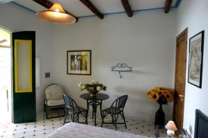 a dining room with a table and chairs in a room at Casa Gialla B&B in Lipari