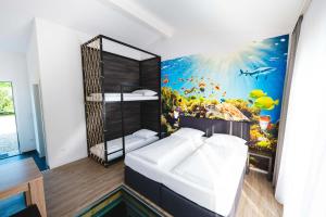 a bedroom with a fish mural on the wall at Pension am Park in Rust