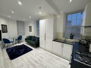 a kitchen and living room with a couch and a table at Beautiful 1-Bed Apartment in Walton on the Naze in Walton-on-the-Naze