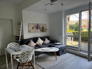 a living room with a couch and a table at Ferienwohnung an der Elbe in Dresden