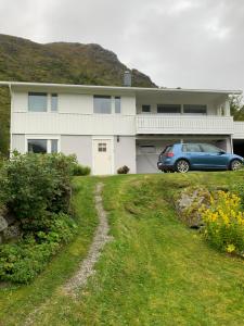 a house with a car parked in front of it at Liten leilighet med to soverom in Valberg