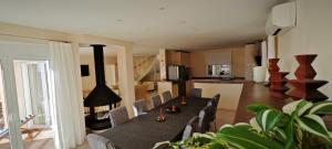 a living room with a table and chairs and a kitchen at Casa Amaryllis in Mijas Costa