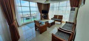 an aerial view of a living room with a large window at Sipadan Inn Service Apartments Semporna in Semporna
