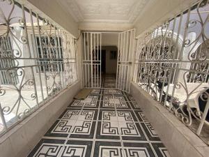a hallway with wrought iron gates and a tile floor at The Girls Guest house in Bathurst