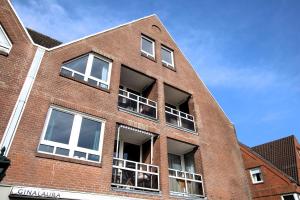 a brick building with balconies on the side of it at Sandwall 2_ Whg_ 6 in Wyk auf Föhr