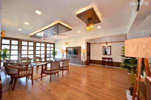 a dining room and living room with a table and chairs at EKOSTAY Gold - Amara Villa in Alibaug