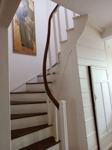 a staircase in a house with a painting on the wall at ΚΥΑΝΟΝ παραδοσιακή μονοκατοικία στην Φλώρινα in Florina