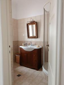 a bathroom with a sink and a shower at ΚΥΑΝΟΝ παραδοσιακή μονοκατοικία στην Φλώρινα in Florina