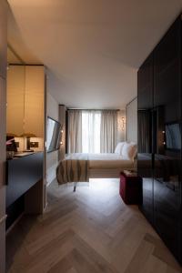 a hotel room with a bed and a window at The Brondesbury by Nestor in London