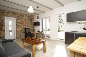 ミデルハーゲンにあるnaturnah, mit Terrasse, Garten und Meerblick - Ferienwohnung auf dem Teschenbergのソファとテーブルのあるリビングルーム