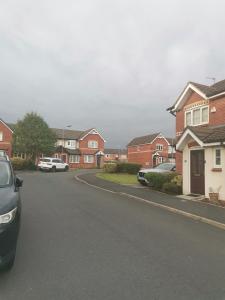 a street in a residential neighborhood with houses at Beautiful 1-Bed House in Manchester in Manchester