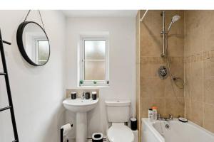 a bathroom with a toilet and a sink and a shower at Beautiful Lincoln Abode - Sleeps 6 - Parking in Lincoln