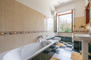 La salle de bains est pourvue d'une baignoire, d'un lavabo et de toilettes. dans l'établissement Villa Mauro su mare, à Calasetta