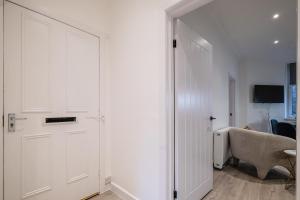 a white closet with a door in a room at Holburn Hideaway - SJA Stays - Luxury 2 Bed Apartment in Aberdeen