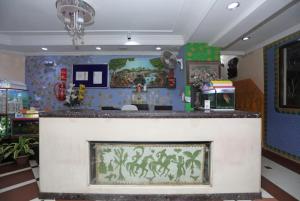 a bar in a room with a fish painting at Hotel Ashray Near Golden Beach Luxury Stay in Puri