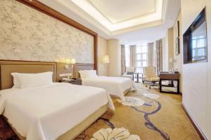 Ένα ή περισσότερα κρεβάτια σε δωμάτιο στο Days Hotel by Wyndham Logan City Huizhou