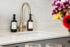 a kitchen counter with two bottles of wine on a sink at Luxury Scottish Hot Tub Getaway in Gatehouse of Fleet