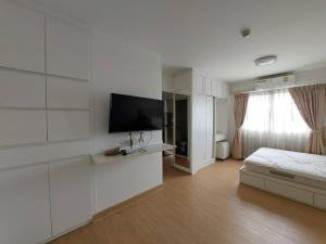 a white room with a bed and a flat screen tv at A Room in Point Condo in Ban Lam Phak Kut