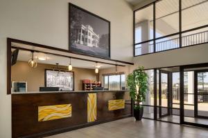 a lobby of a restaurant with a reception desk at Super 8 by Wyndham Ocean Springs Biloxi in Ocean Springs