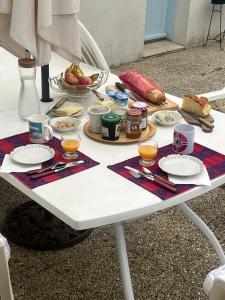 a white table with food and drinks on it at Chez Frédérique in Saint-Pierre-dʼOléron