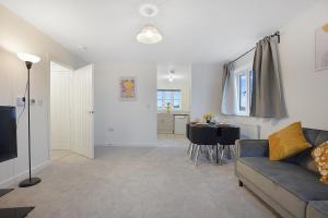 a living room with a couch and a table at Gravesend 2 Bed Apartment-2 minutes walk from shops, Restaurants and Motorway. Sleep upto 5 in Northfleet