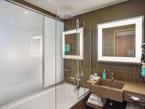 a bathroom with a tub and a sink and a shower at Novotel Paris Gare De Lyon in Paris
