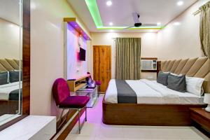 a hotel room with a bed and a chair at Hotel Ashray Near Golden Beach Luxury Stay in Puri