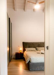 a bedroom with a bed in a white room at Green Woody Home in Rome