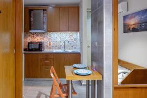 a small kitchen with a table and a sink at Old Town Studio's Rethymno City in Rethymno