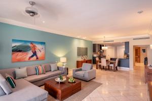 a living room with a couch and a table at Sports Illustrated Resorts Marina and Villas Cap Cana - All-Inclusive in Punta Cana
