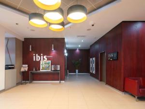 a lobby with a waiting area with aubs sign on the wall at Ibis Astana in Astana