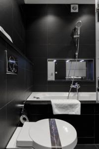 a bathroom with a white toilet and a sink at The Queen Luxury Apartments - Villa Fiorita in Luxembourg