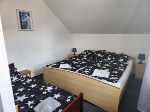 a bedroom with a bed with black and white stars at Penzion u Martina in Liberec