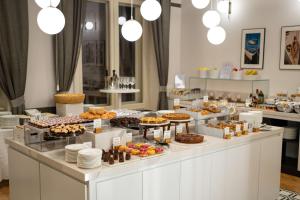 a buffet with many different types of pastries and desserts at DoubleTree By Hilton Trieste in Trieste +37 photos