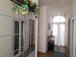 a hallway with mirrors and a chandelier at CASA MONTEFINESE in Casamassima