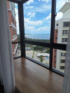 a large window with a view of the ocean at Sabra Palmvillage mikocheni in Dar es Salaam